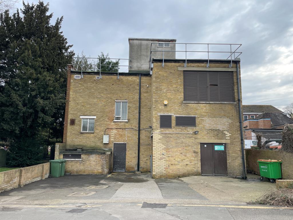 Lot: 145 - VACANT COMMERCIAL PREMISES IN HIGH STREET LOCATION - Rear of building showing rear access and parking spaces